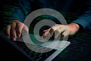 A close-up of hands typing on a laptop keyboard with digital code overlay, representing software development, cybersecurity, or