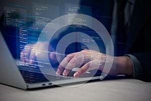 Hands typing on laptop with programming code on screen, representing software development. Perfect for coding, IT solutions,
