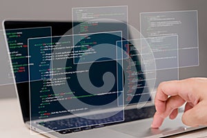 Hands typing on laptop with programming code on screen, representing software development. Perfect for coding, IT solutions,