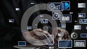 Hands typing on a laptop surrounded by digital graphics and data visualizations illustrating technology and data