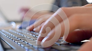 Hands typing on a modern trendy keyboard. Online concept. Work from home. Close up on man s hands inputting information