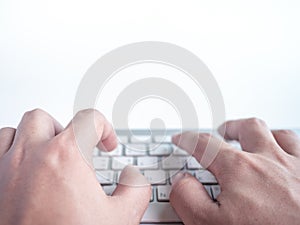 Hands typing on remote control wireless computer keyboard