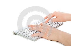 Hands typing on the remote wireless computer keyboard