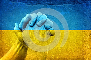 Hands on Ukrainian Flag