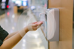 Hands under the automatic alcohol dispenser. Infection and hospitably concept. save and protect disease virus against germs and cl