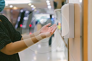 Hands under the automatic alcohol dispenser. Infection and hospitably concept. save and protect disease virus against germs and cl