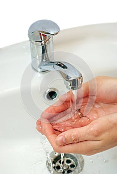 Hands under water stream