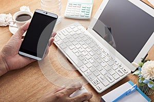 hands using cell phone and laptop on desk wood and Business work