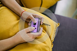 Hands using game controller. Playing video games