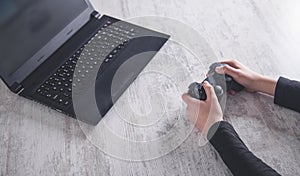 Hands using game controller. Playing video games