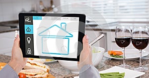 Hands using smart home app on digital tablet