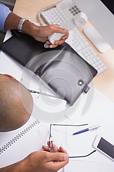 Hands using telephone while doing paperwor paperworkdesk