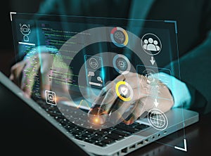 hands using typing keyboard with creative binary coding hologram on blurry background. Software programming code.