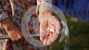 Hands of very old woman taking pills, close up of an elderly woman hand her medication, health issues at an old age