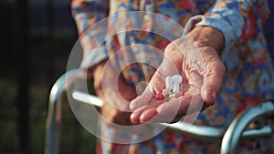 Hands of very old woman taking pills, close up of an elderly woman hand her medication, health issues at an old age