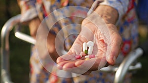 Hands of very old woman taking pills, close up of an elderly woman hand her medication, health issues at an old age