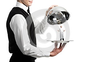 Hands of waiter with cloche photo