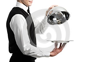 Hands of waiter with cloche lid