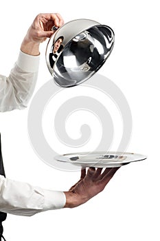 Hands of waiter with cloche lid