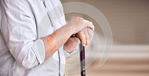 Hands, walking stick and elderly person in home for support, healthcare and help in retirement. Closeup, banner and