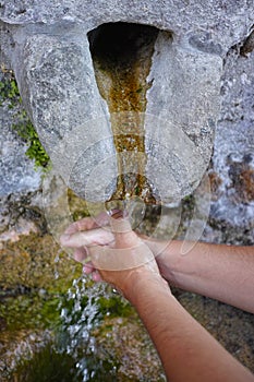 Hands washing under water source