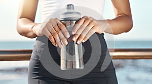 Hands, water bottle and fitness person holding beverage, drink or liquid for hydration, wellness or sports exercise