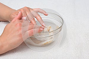 Hands in water with seashells