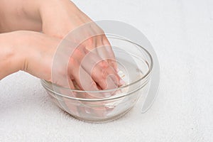 Hands in water with seashells