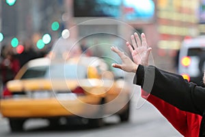 Hands waving for a cab taxi in new york