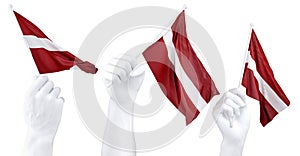 Hands waving Latvia flags isolated on white