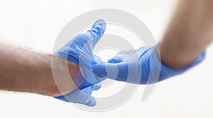 Hands wearing blue medical latex gloves Protection against flu, virus and coronavirus. Health care and surgical concept. Correct