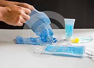 Hands wearing medical gloves with alcohol gel cleaning concept for Covid-19 virus.