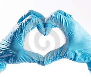 Hands wearing PPE gloves forming a shape of a heart