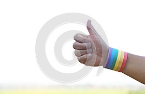 Hands wears rainbow colors stripes wristband, Thumbs up. Concept, Lgbtq+ celebration in pride month,