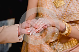 hands of a wedding couple, Groom put a ring on finger of his lovely wife, wedding ceremony