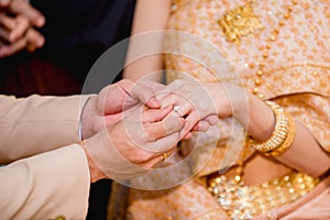 hands of a wedding couple, Groom put a ring on finger of his lovely wife, wedding ceremony