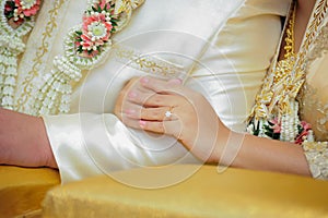 Hands of a wedding couple, Groom put a ring on finger of his lovely wife, wedding ceremony