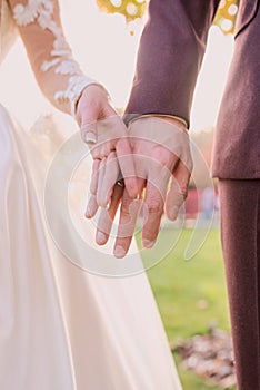 Hands of wedding couple in love.