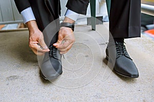 Hands of wedding groom getting ready suit