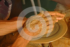 Hands on wheel of potter