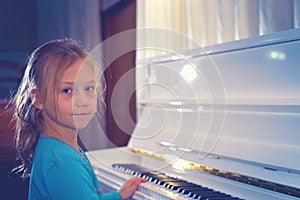 Hands on the white Keys of the Piano Playing a Melody. Women`s H