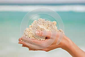 Hands with white sand