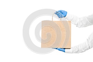 Hands in white sleeves in sterile gloves of courier for safe delivery of food in eco-friendly package.