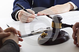 Hands of wife, husband signing decree of divorce, dissolution, canceling marriage, legal separation documents, filing