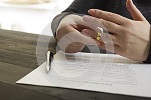 Hands of wife, husband signing decree of divorce, dissolution, canceling marriage, legal separation documents, filing