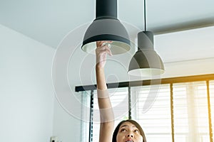 Hands woman changing with new LED lamp light bulb