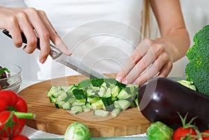 Hands of a woman cutting vegetables