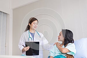 Hands woman doctor reassuring her female asian patient in hospital room,Doctor giving a consultation and encouragement to patient