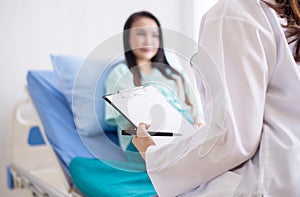 Hands woman doctor reassuring her female patient in hospital room,Doctor giving a consultation and encouragement to patient,