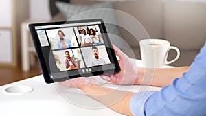 Hands of woman having video chat on tablet pc